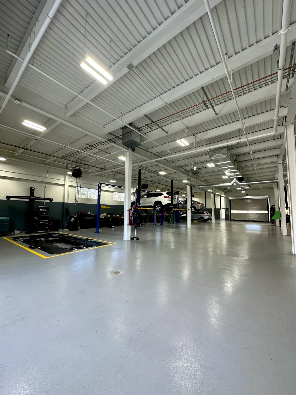 Empire Subaru service bay with bright high-ceiling commercial LED lighting
