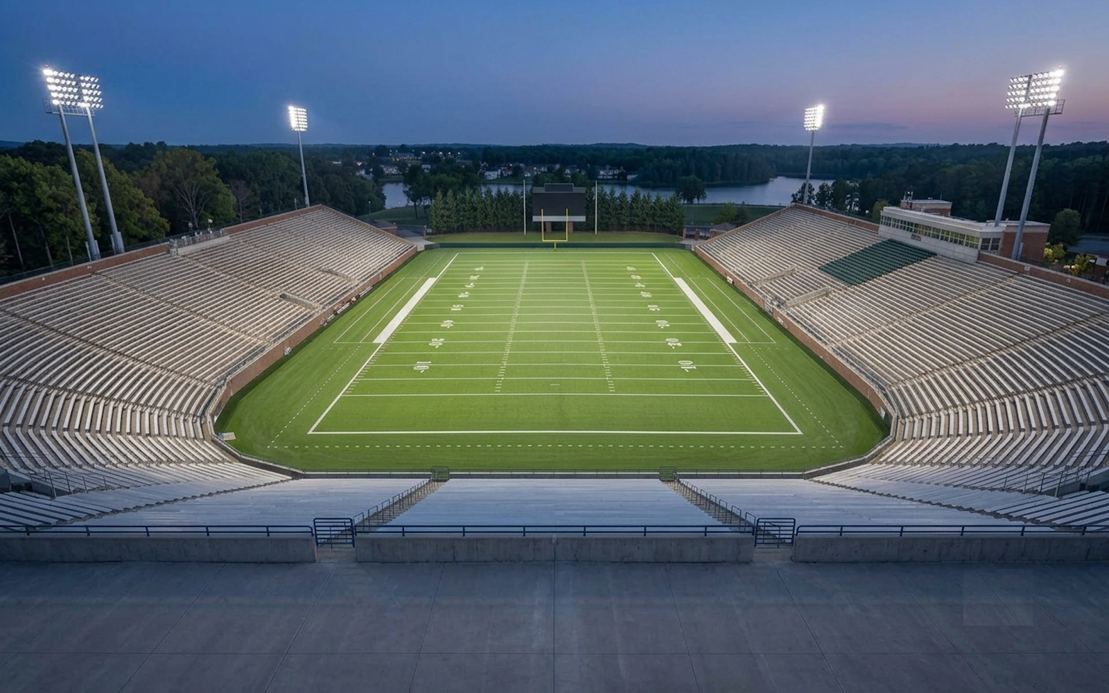 Football field LED lighting retrofit replacing older metal halide stadium lights
