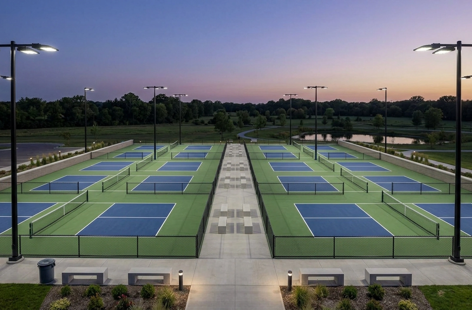 Outdoor pickleball courts illuminated by controlled LED lighting at dusk