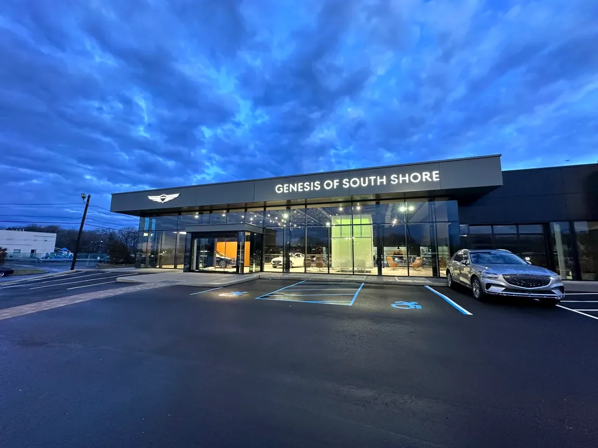 Genesis of South Shore dealership exterior with commercial LED lighting at dusk