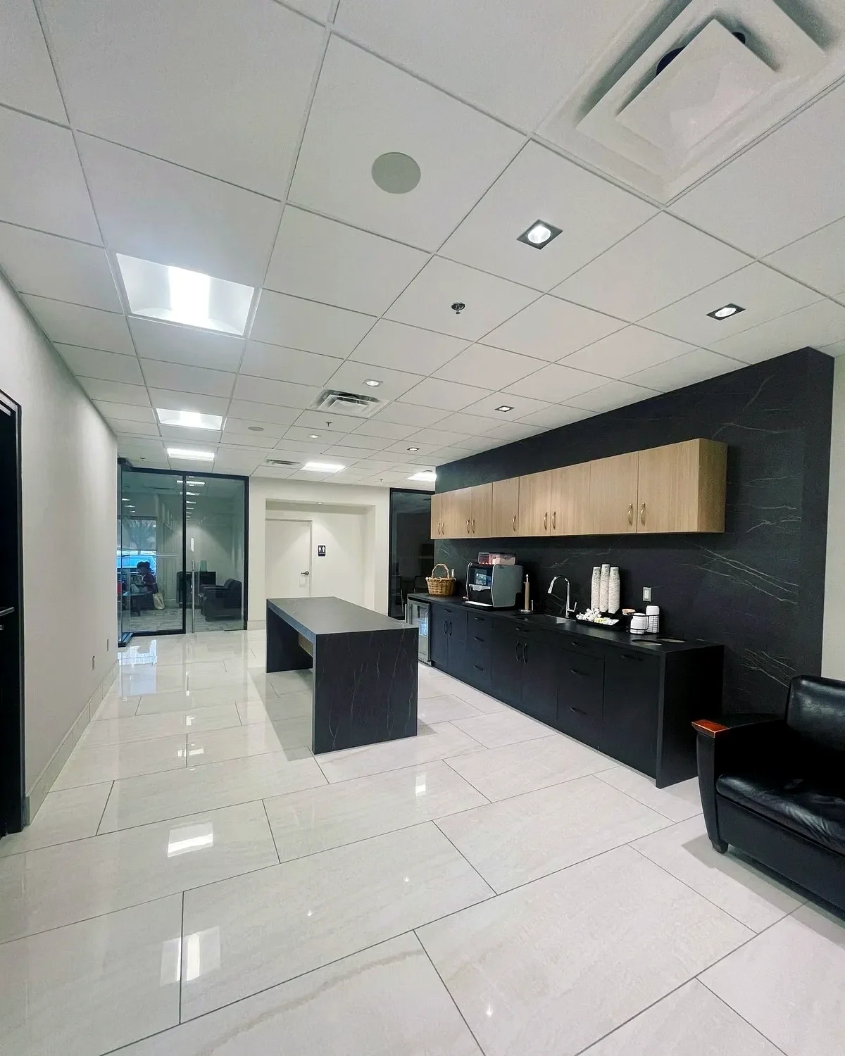 Commercial interior with LED troffers, panel lighting and recessed square fixtures